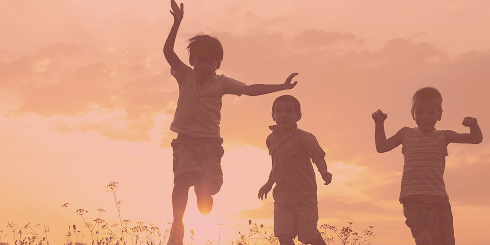 Children running at sunset